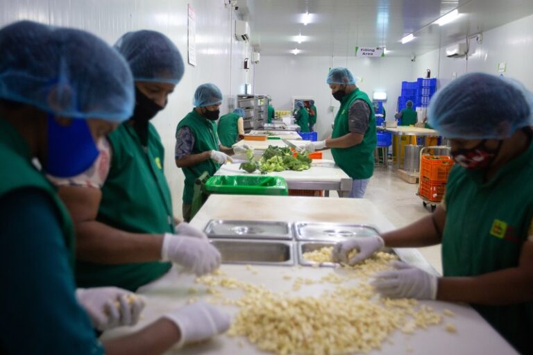Employees chop vegetables inside a Big Basket distribution centre in Hoskote, on the outskirts of Bengaluru, India, Wednesday, 11 August, 2021.