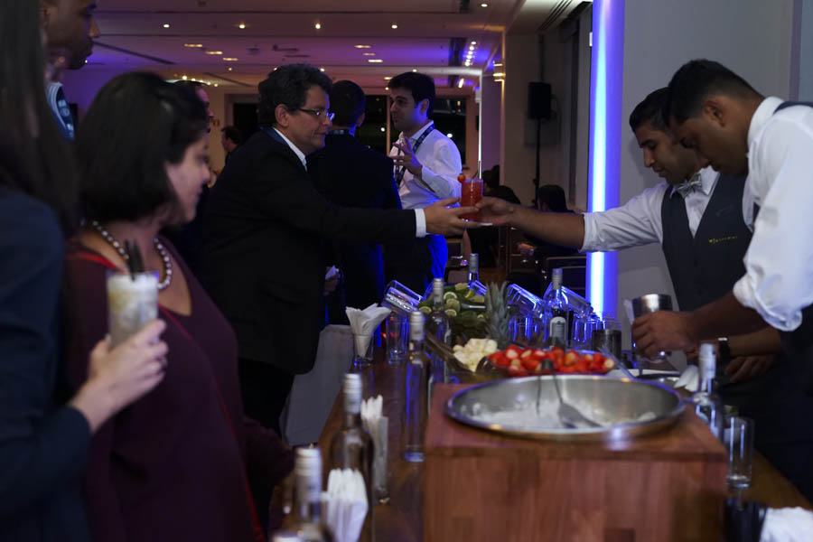 Attendees of the summit attending cocktail hour.