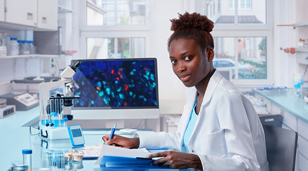Female African scientist works in modern biological laboratory